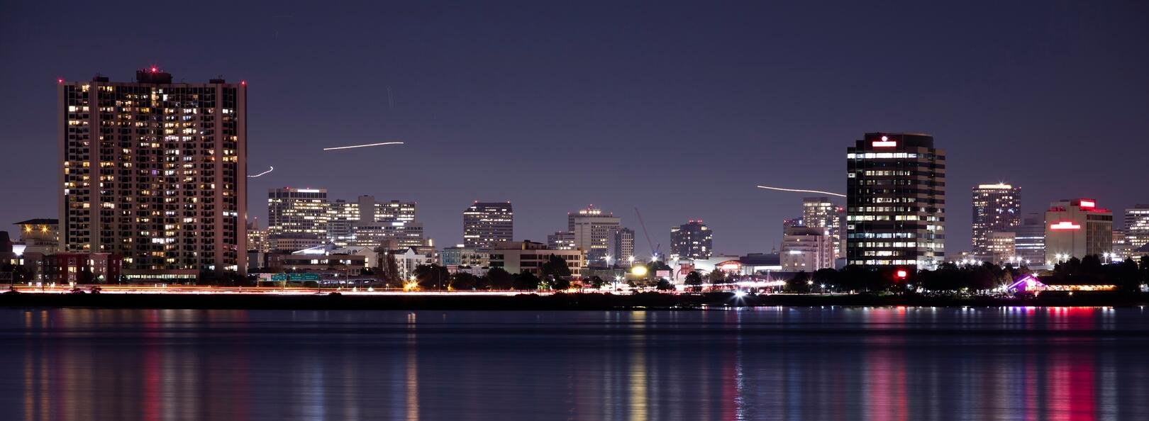 Emeryville California waterfront skyline at night reflected in San Francisco Bay